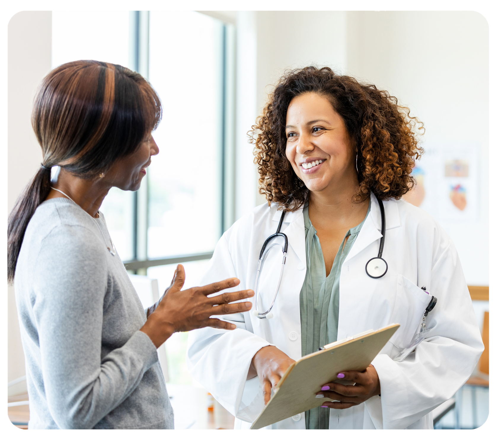 Female doctor speaks with female patient